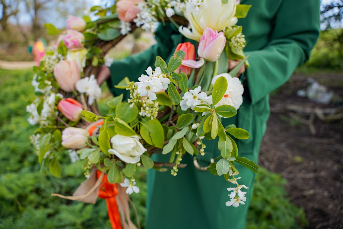 a woman holding a bouquet of flowers in her hands